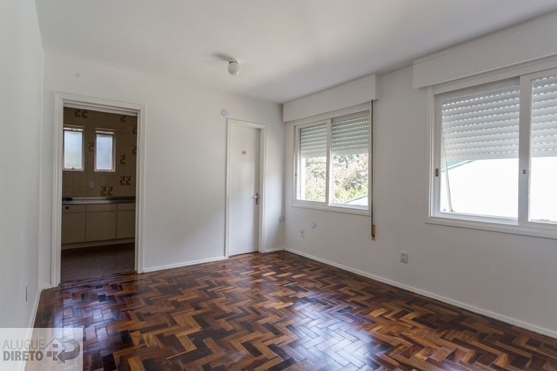Sala de estar com piso em parquet espinha de peixe e duas janelas amplas